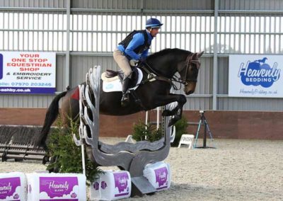 Rider on jump with blend stock and signage